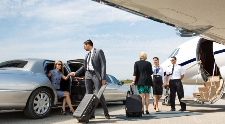 A group of people standing around an airport.