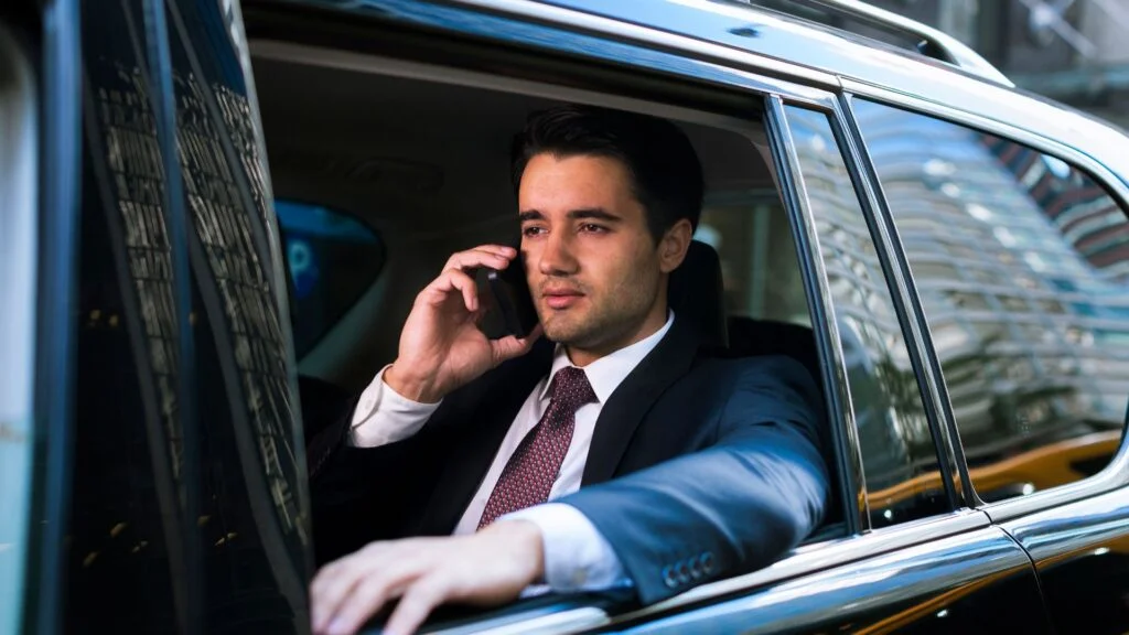 A man in suit and tie talking on his cell phone.