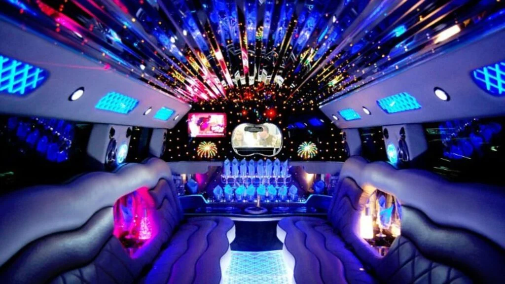 A limo with lights and a bar in the back.