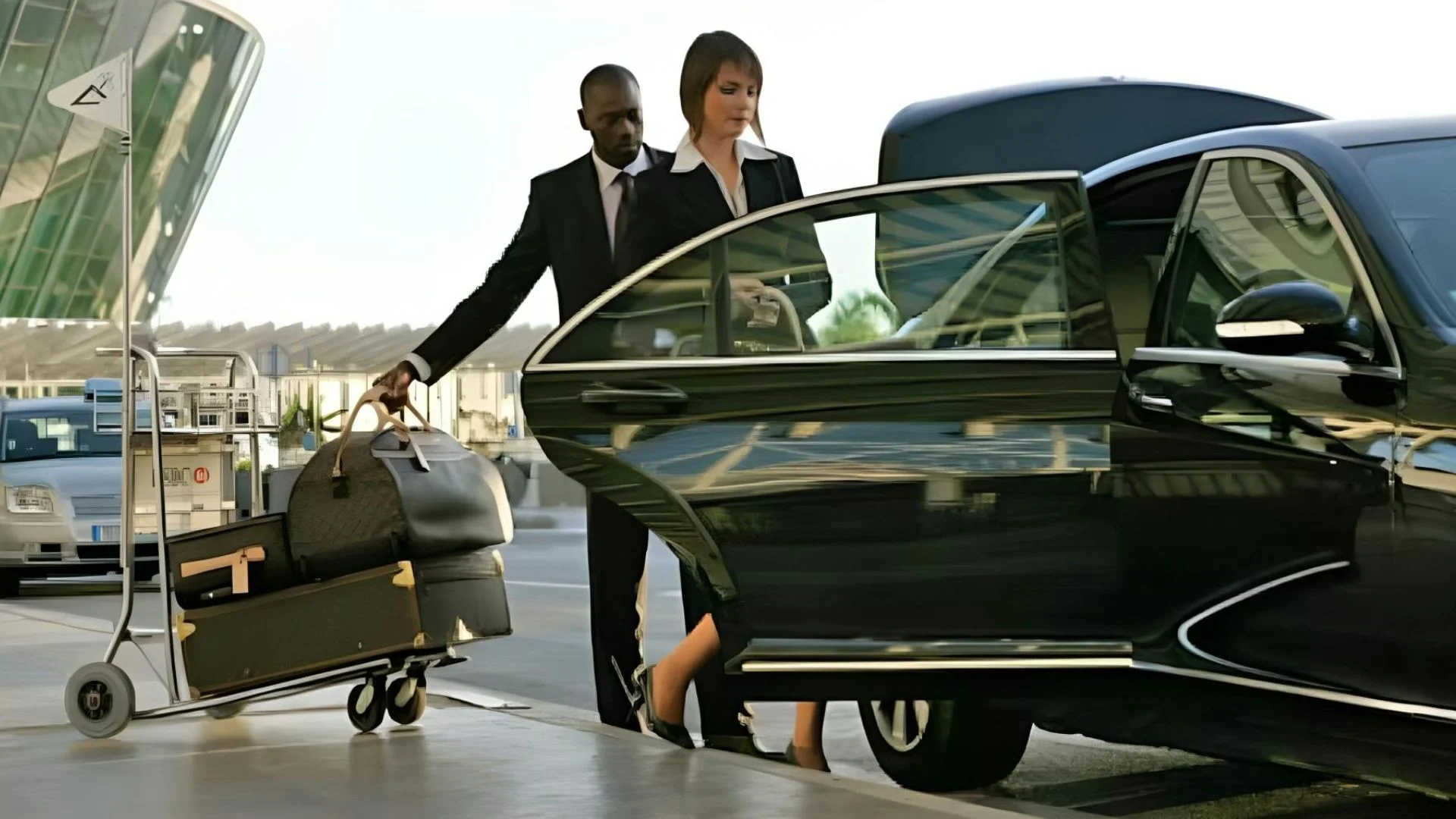 Eco-Friendly-Airport-Transfers A man and woman loading luggage into an suv.