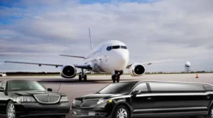 A large white airplane on the runway with cars parked in front of it.