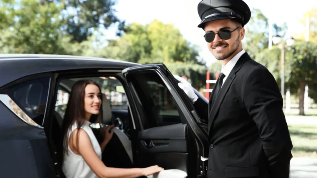 A man in black suit and hat standing next to a woman.