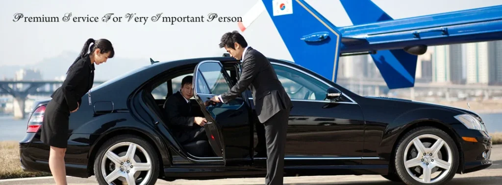 A man in suit and tie getting into a car.