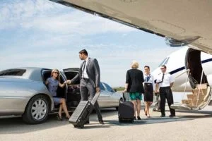 A group of people standing around an airport.