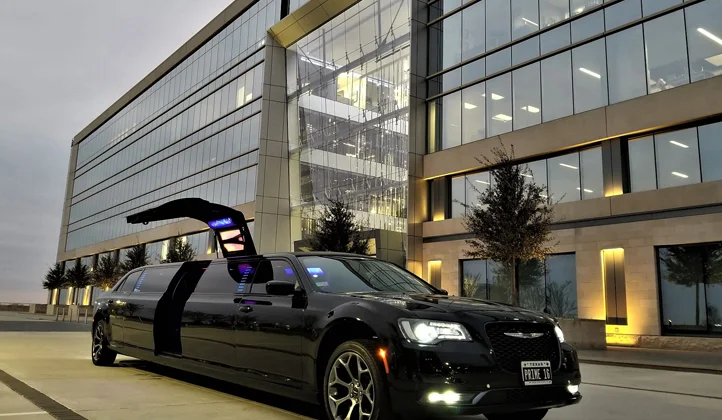 A black limo parked in front of a building.