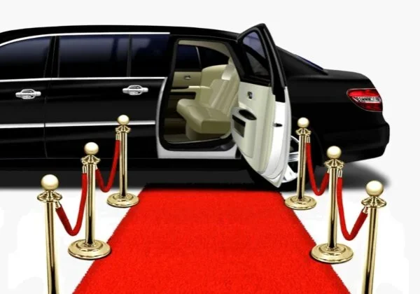 A limo is parked on the red carpet.