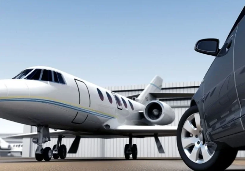 A car parked in front of an airplane.