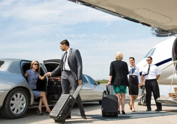 A group of people standing around an airport.