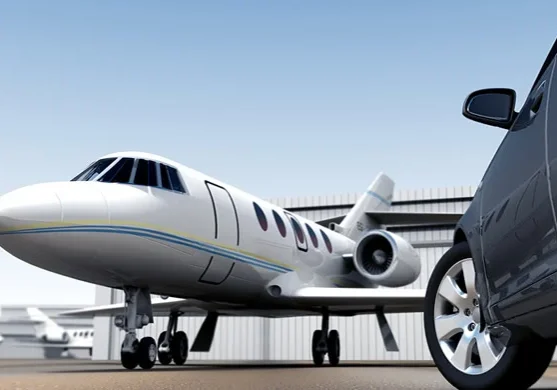 A white airplane sitting on top of an airport runway.