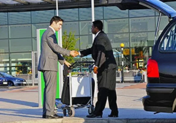 Two men shaking hands outside a building