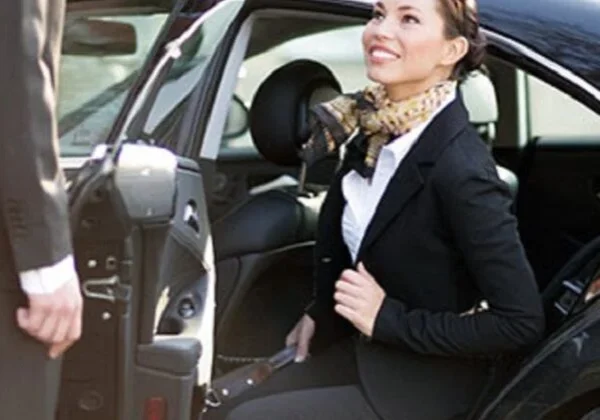 A woman in black jacket sitting inside of car.