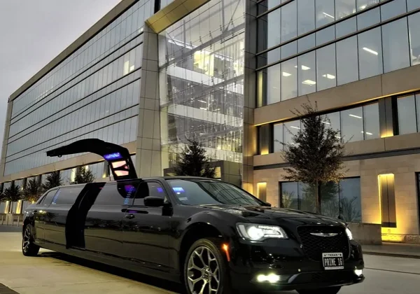 A black limo parked in front of a building.